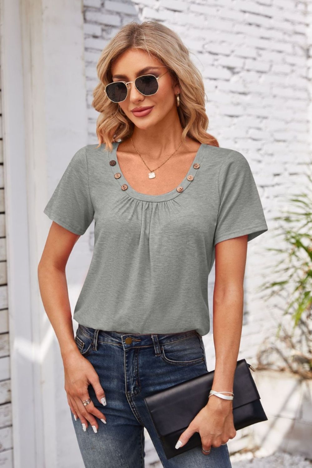 Gray short sleeve top with gathered yoke and button trim neckline.