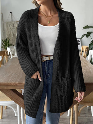 Black textured bouclé open-front cardigan with pockets and long sleeves.