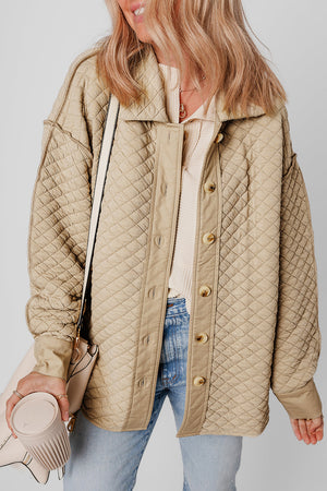 Beige diamond quilted oversized button-up jacket with spread collar and button front.
