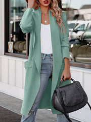 Turquoise open-front duster cardigan with pockets, styled with jeans and a white top.