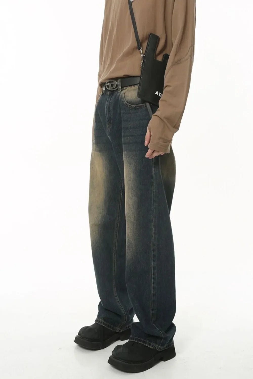 Faded wash baggy denim trousers in dark blue with a distressed look.