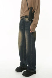 Faded wash baggy denim trousers in dark blue with a distressed look.