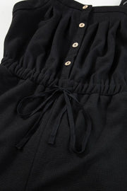 Black waffle knit jumpsuit with drawstring waist and button front detail