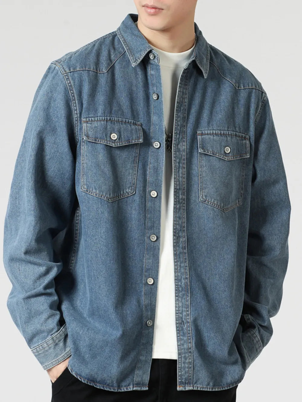 Classic relaxed fit blue denim shirt with button-down front and chest pockets, made of 100% cotton.