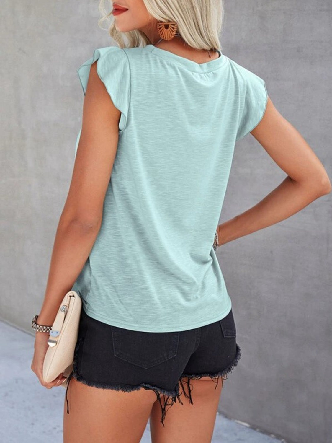 Light blue cotton eyelet yoke flutter sleeve top with a crew neck.