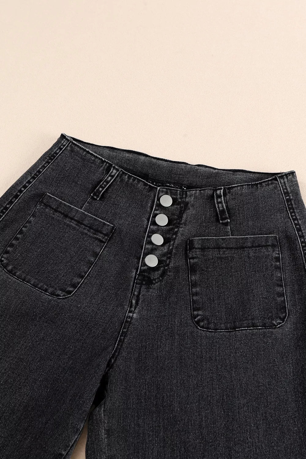 Black denim wide-leg jeans with button-fly and patch pockets.