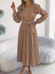 Khaki A-line midi dress with ruffled neckline, long sleeves, and pleated skirt.