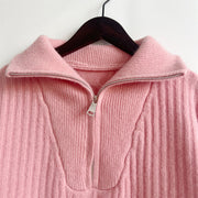 Dusty pink cable knit zip-neck sweater with a ribbed texture and silver zipper detail.