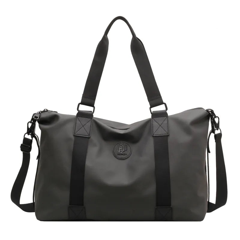 Urban Utility Weekend Bag in dark gray canvas with black straps and logo detail.