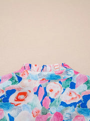Vibrant floral cotton blouse with a ruffled tie neck.