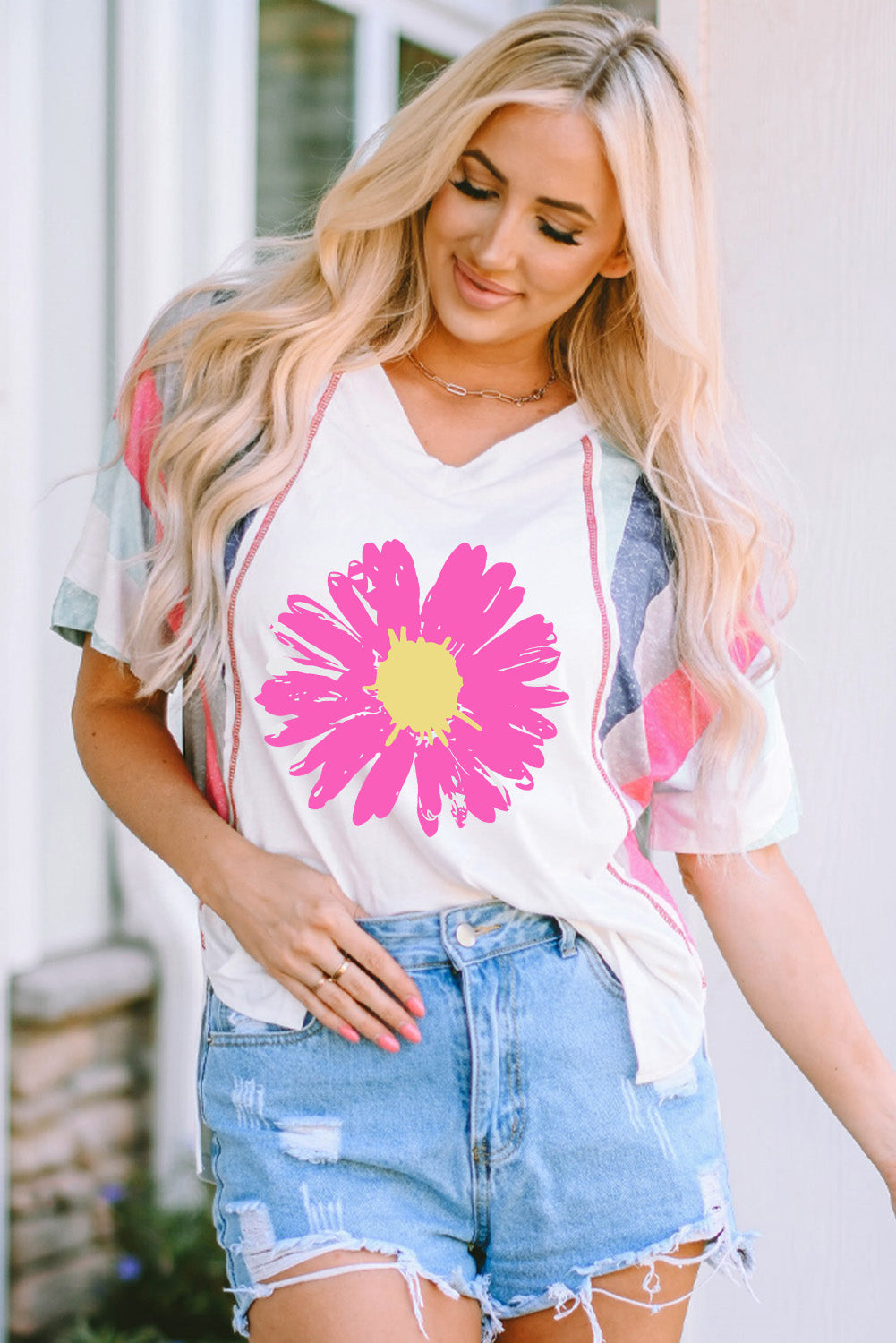 White t-shirt with pink floral graphic and colorblock sleeves