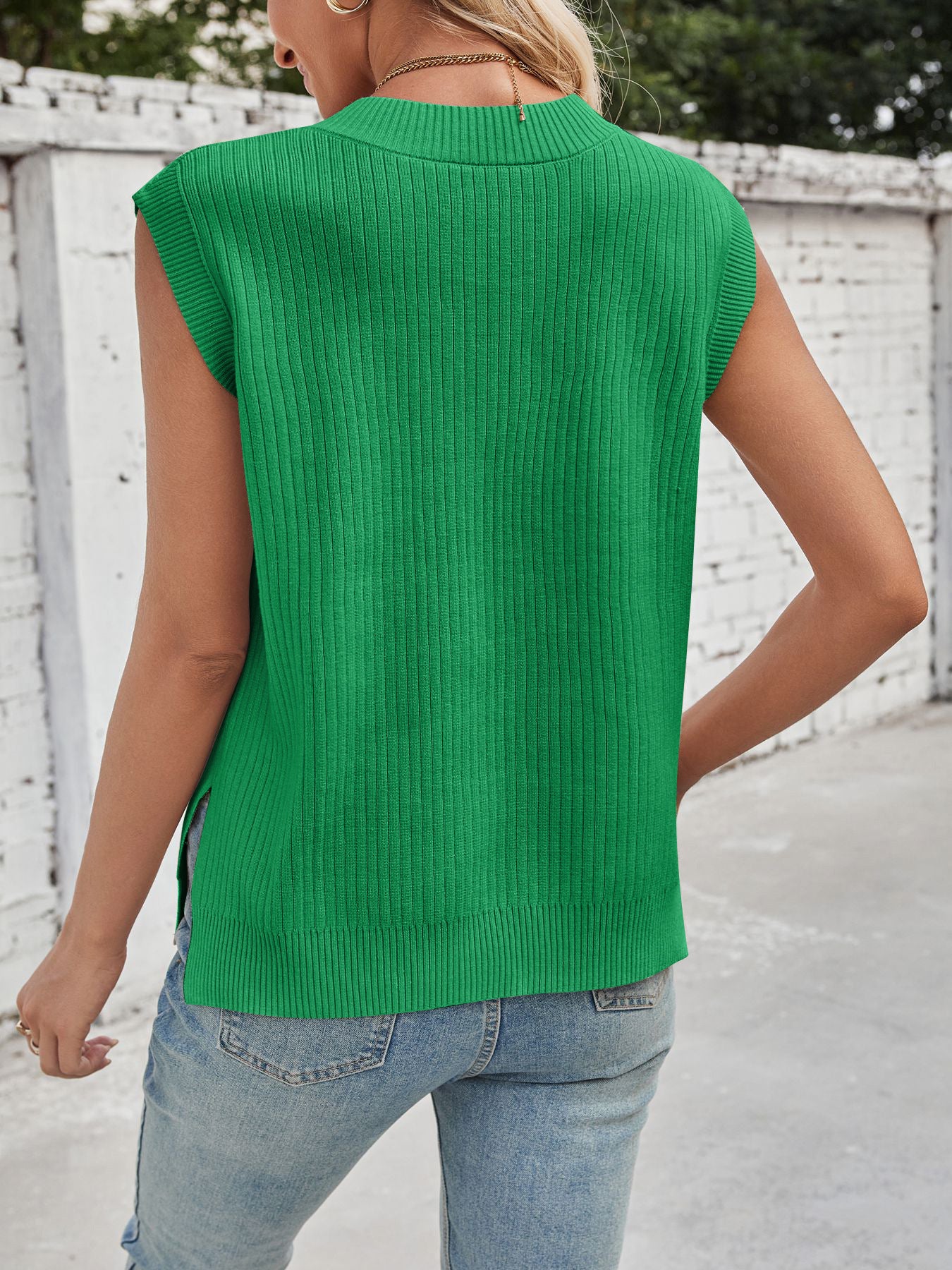Green ribbed V-neck sweater vest with side slits, acrylic blend.