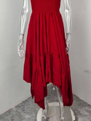 Deep red smocked maxi dress with ruffle hem and flowing skirt.