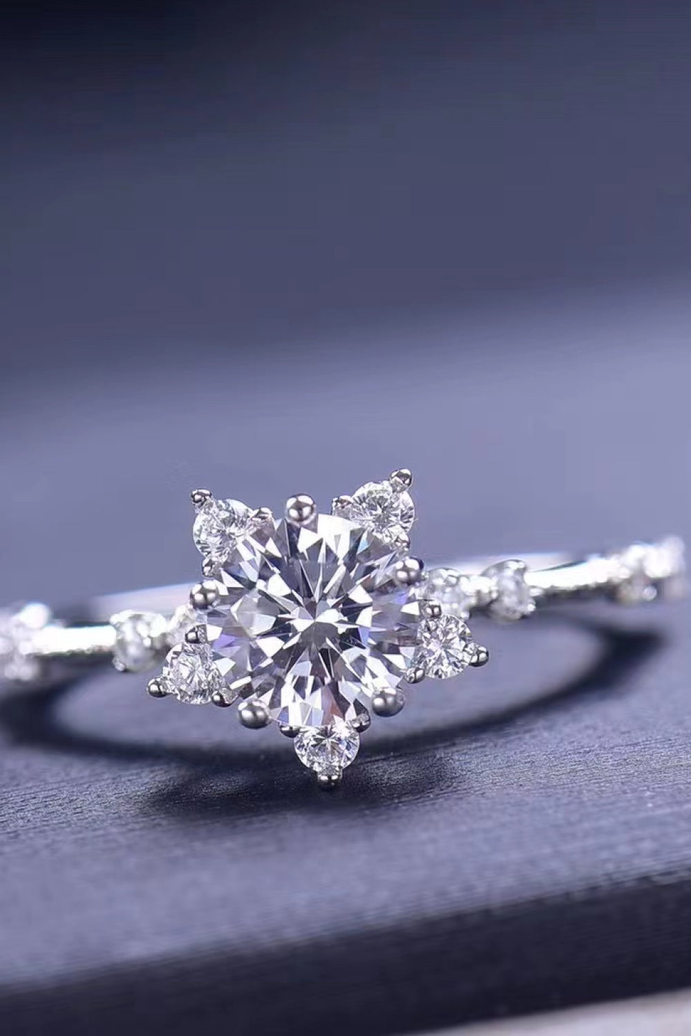 Silver halo ring with a floral diamond center and sparkling band.