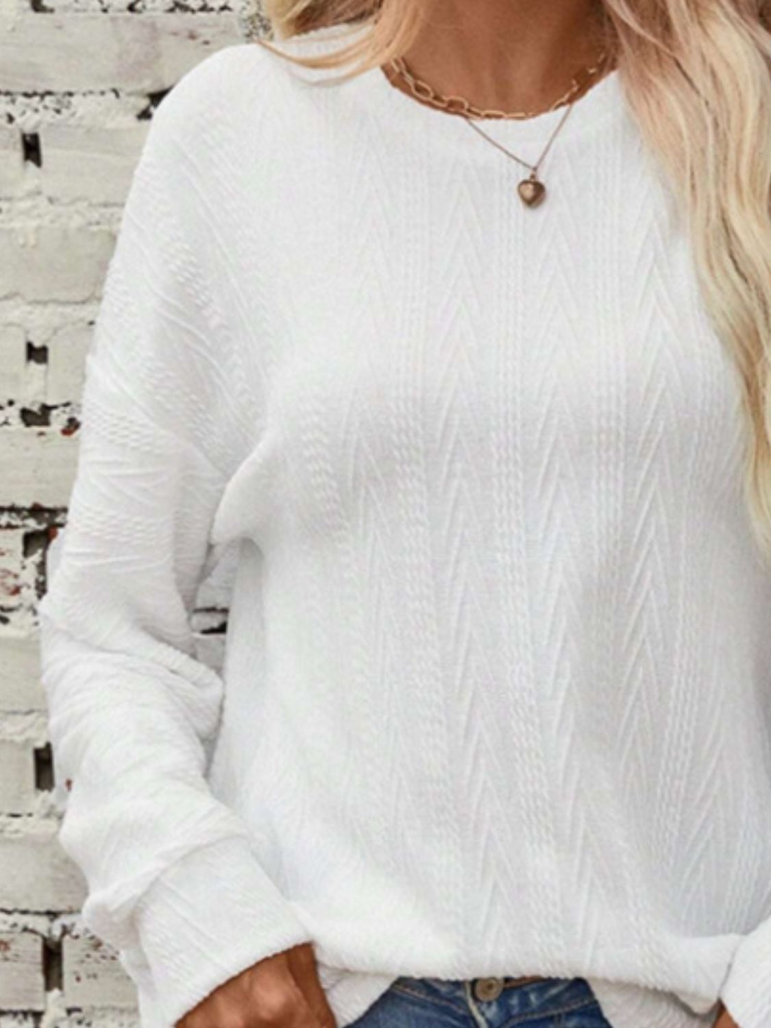 White textured chevron knit crewneck sweater with long sleeves.