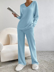 Blue ribbed knit V-neck loungewear set with long sleeves and wide-leg pants.