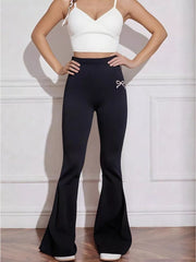 Black flared high-waist active pants with bow emblem detail