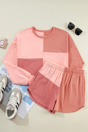 Colorblock lounge set with crew neck sweatshirt and shorts in dusty pink and light blue tones.