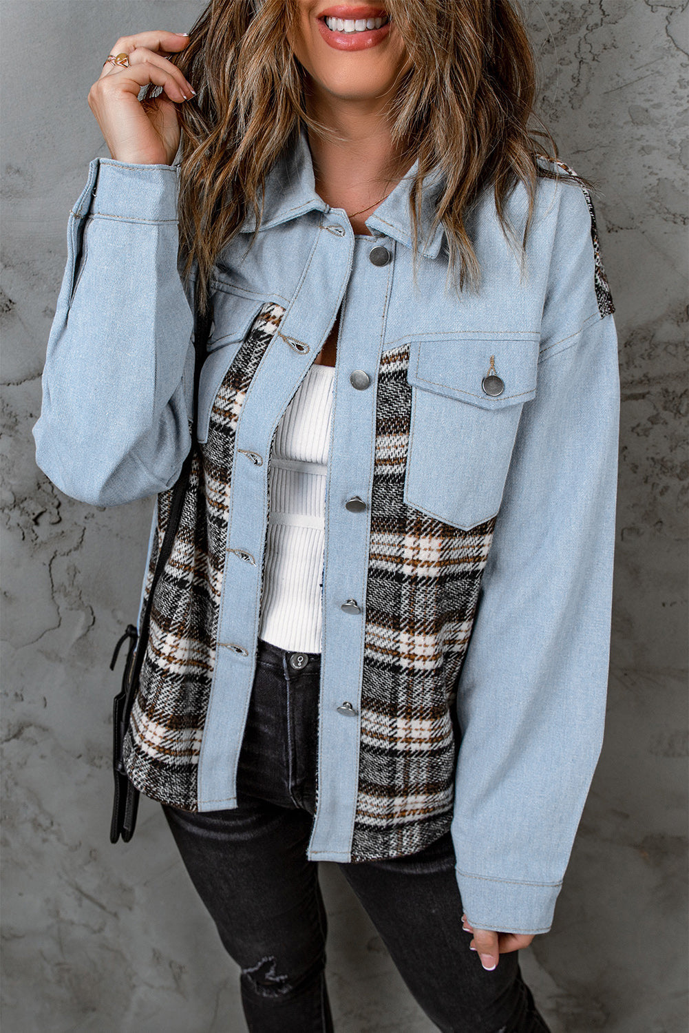 Light blue denim shirt jacket with plaid panels and button front.