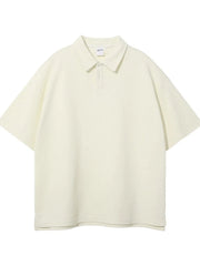 Boxy ivory textured polo shirt with short sleeves and a two-button placket.