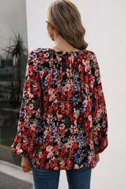 Red floral print blouse with gathered yoke and balloon sleeves.