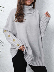 Light gray turtleneck sweater with button cuffs and ribbed details.