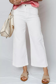 White relaxed fit ankle length denim jeans with pearl embellishments down the side seams.