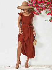 Belted midi dress in brick red with flutter sleeves and tiered skirt.