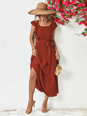 Belted midi dress in brick red with flutter sleeves and tiered skirt.