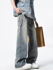 Timeless wide leg vintage jeans in light wash denim with distressed details and a pearl chain accessory.
