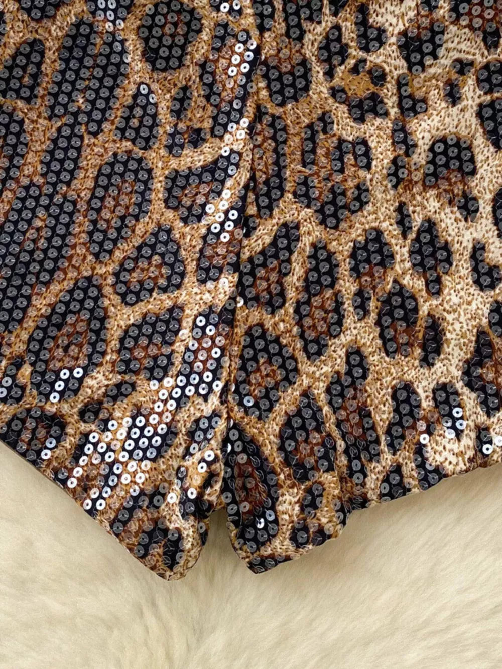Radiant animal print sequin chino shorts with a leopard pattern.