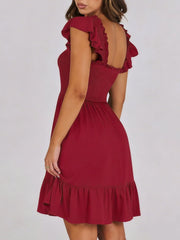 Burgundy smocked mini dress with ruffle hem and flutter sleeves.
