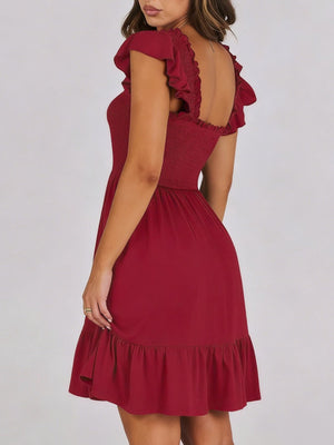 Burgundy smocked mini dress with ruffle hem and flutter sleeves.