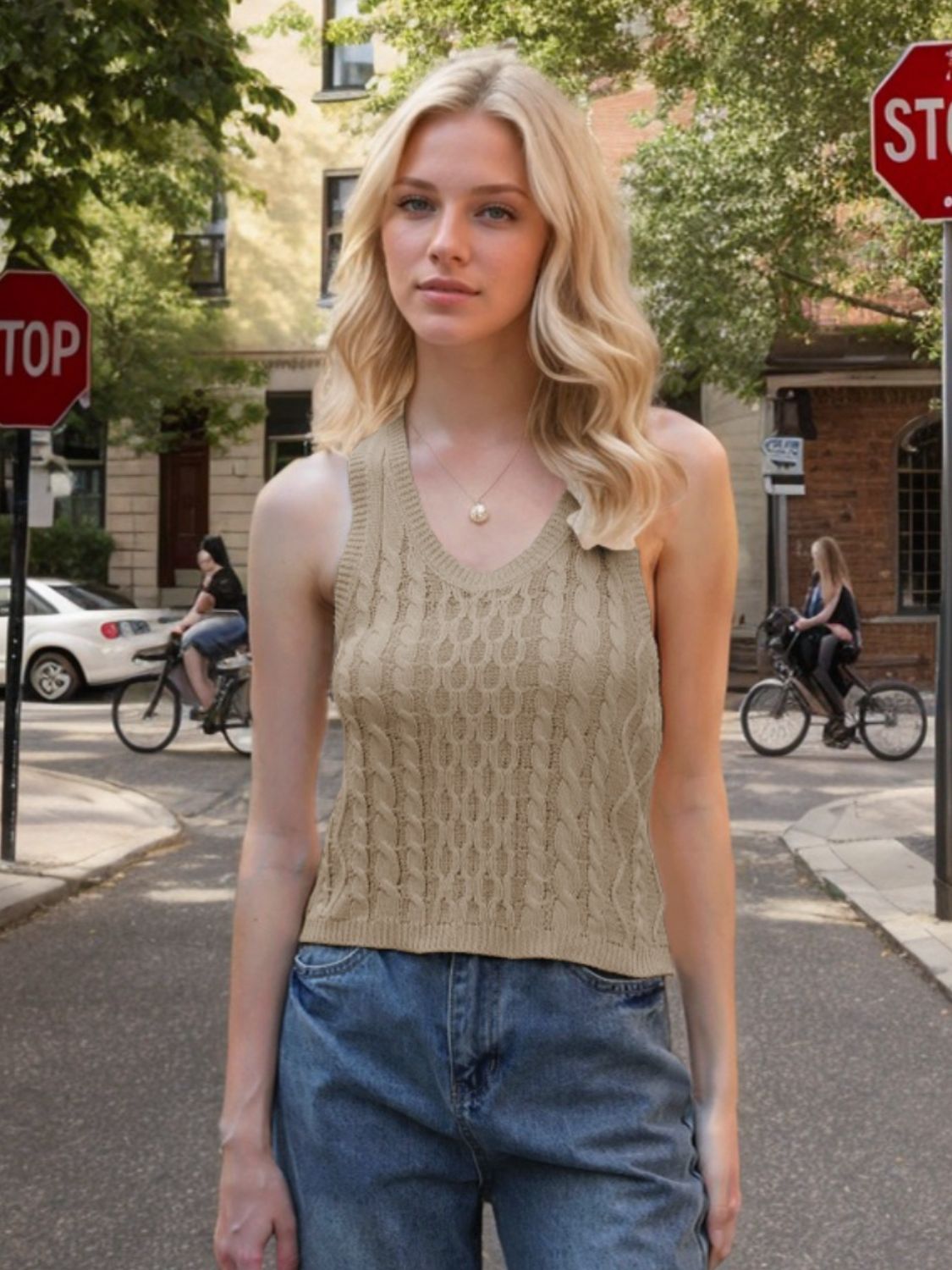 Beige cable knit tank top with V-neck and sleeveless design.