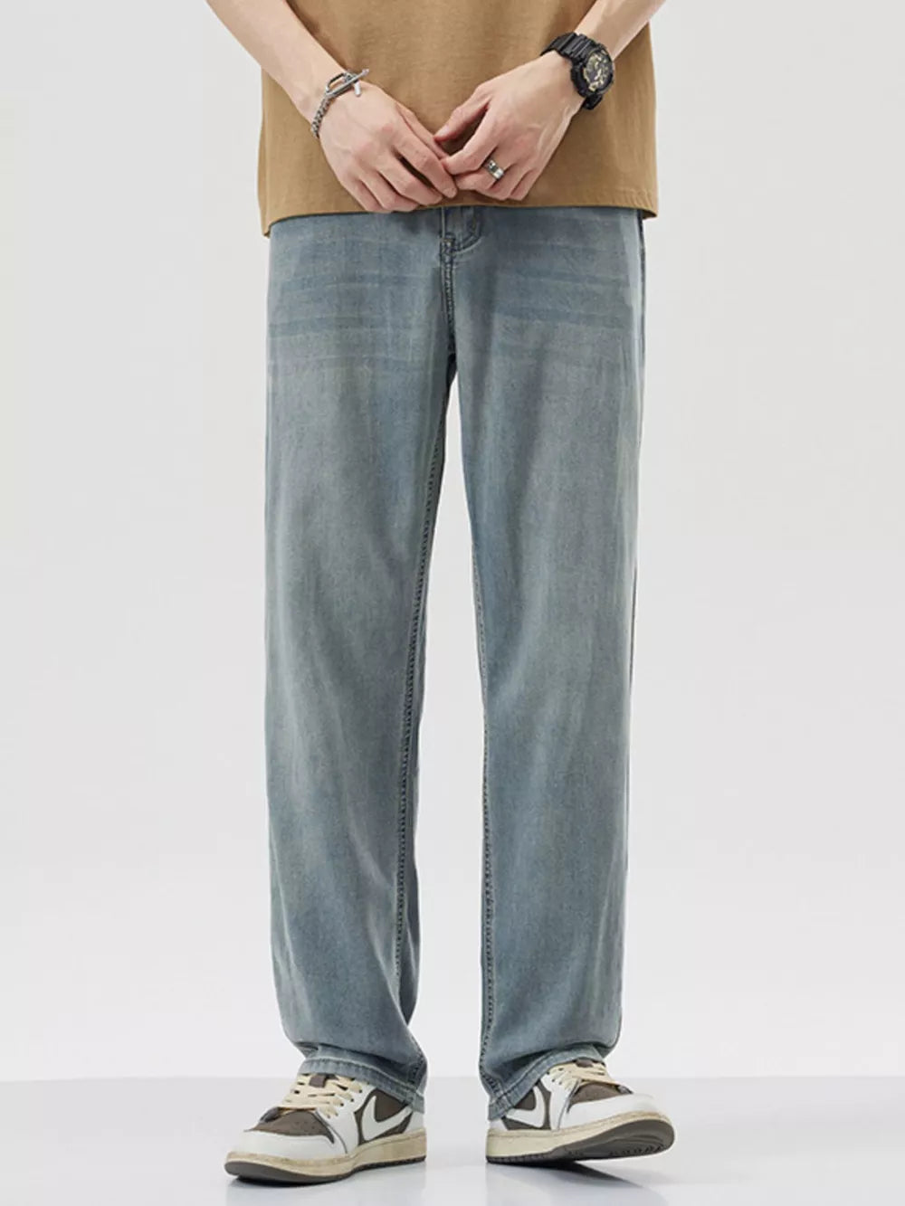 Relaxed fit wide-leg denim trousers in light blue, styled casually.