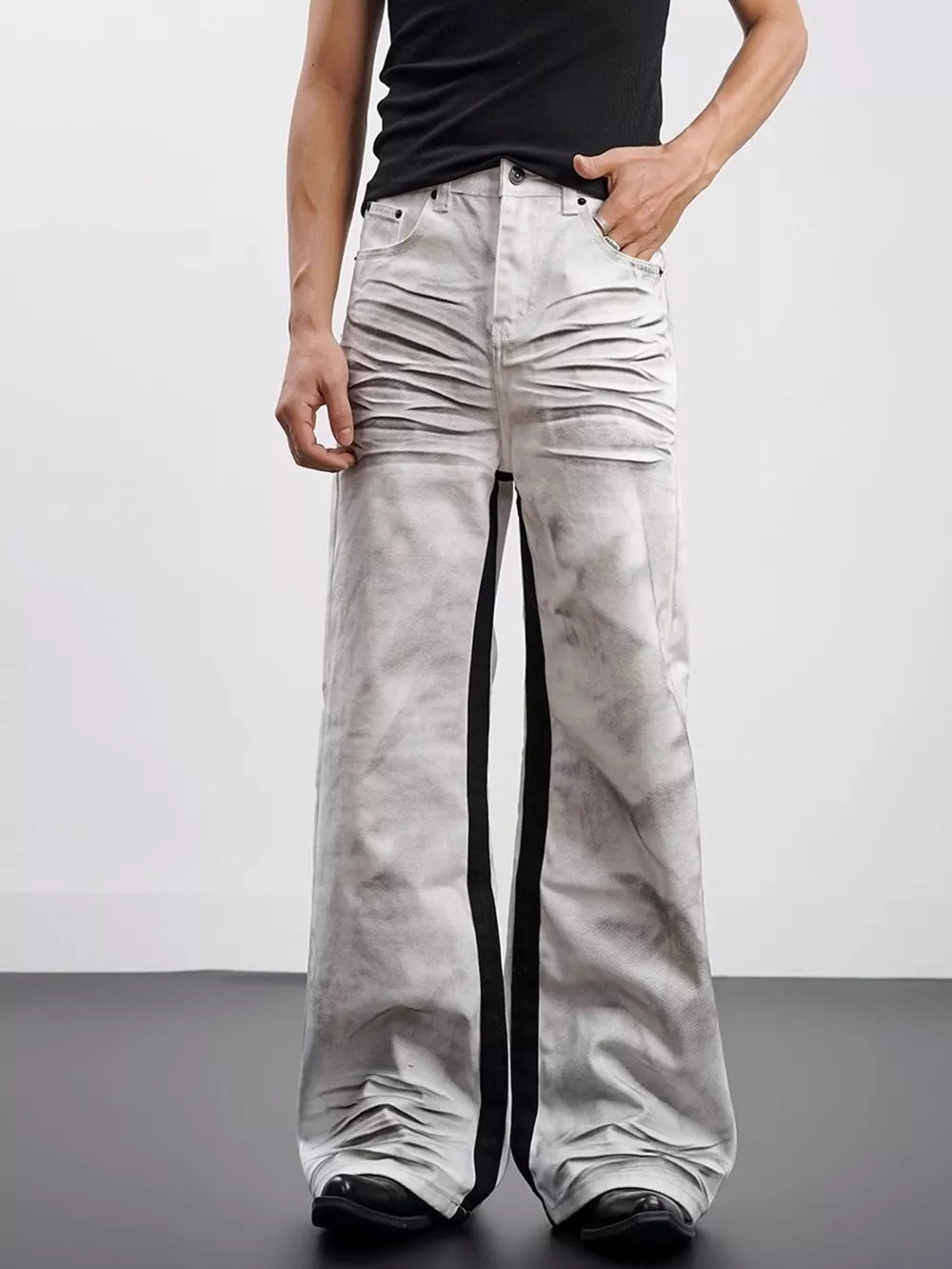 Men's wide-leg jeans in grey tie-dye cotton with black contrast stripes and ruched detail.