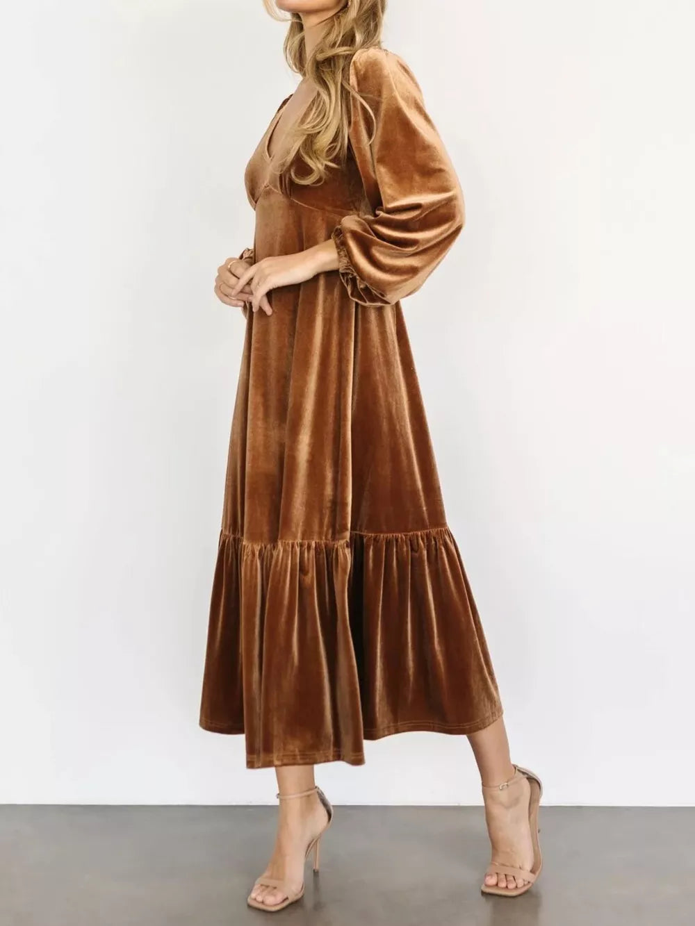 Gold velvet midi dress with tiered skirt, V-neck, and balloon sleeves.