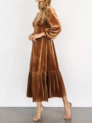 Gold velvet midi dress with tiered skirt, V-neck, and balloon sleeves.