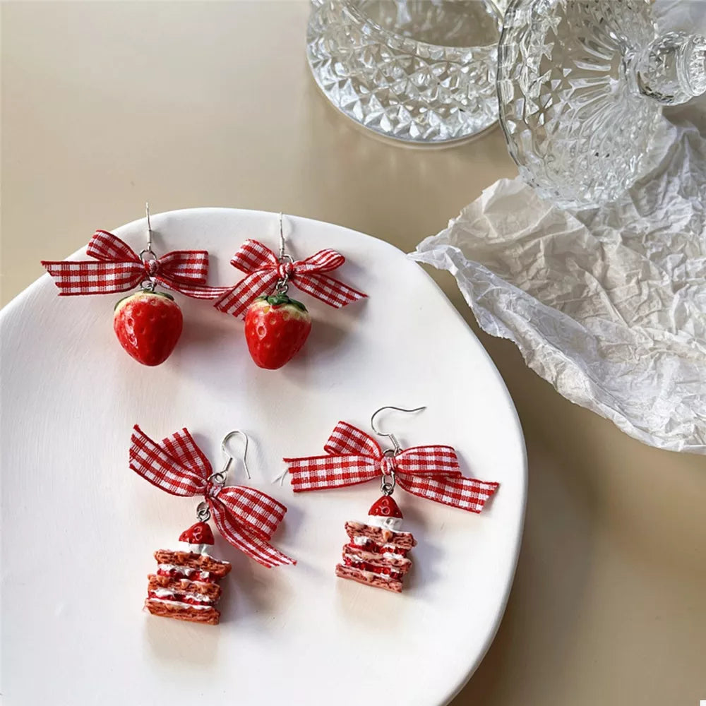 Charming strawberry dangle earrings with red gingham bow accents