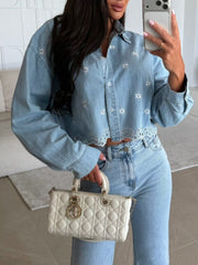 Light wash denim cropped shirt with white floral embroidery and eyelet trim