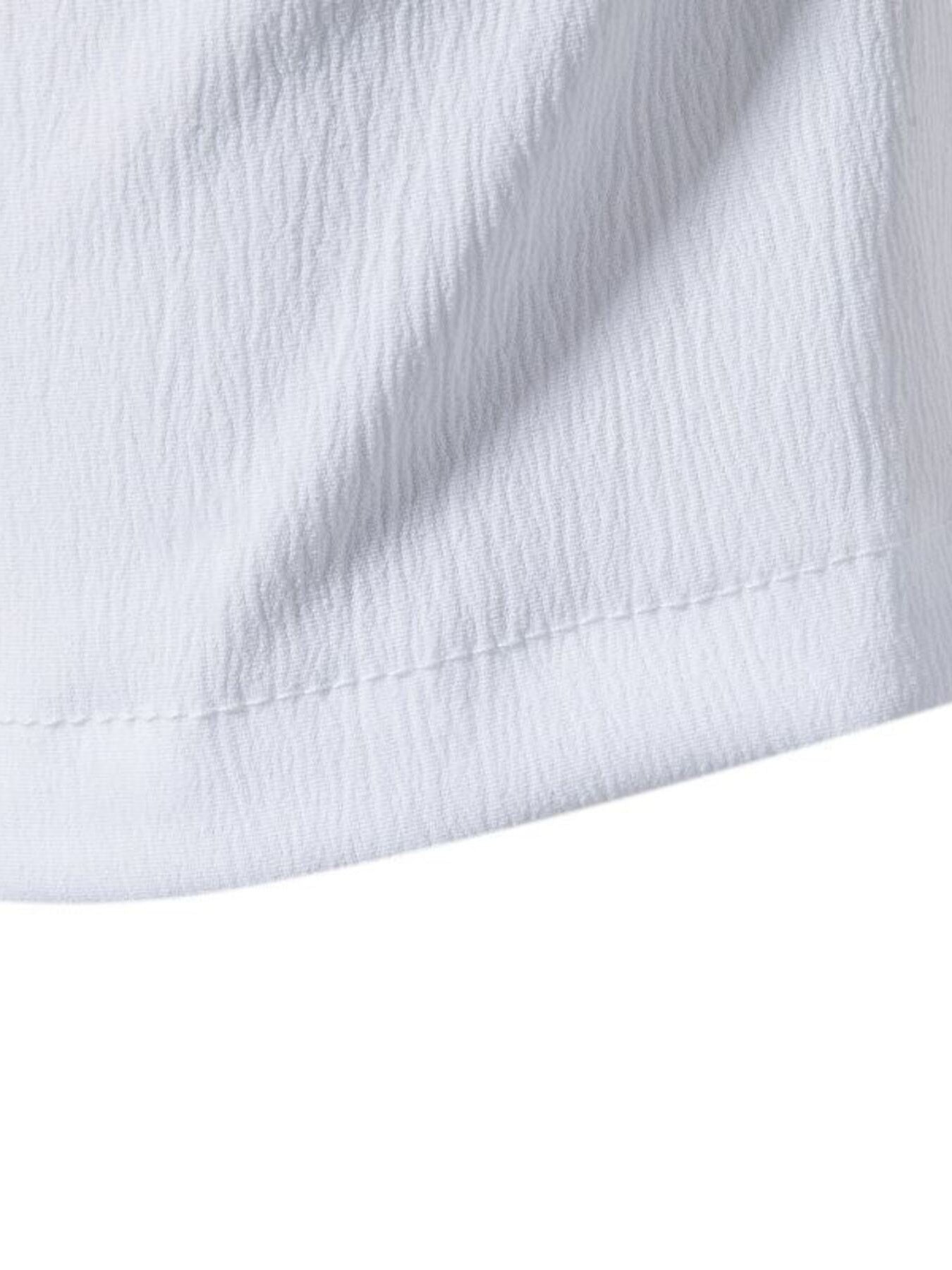 White cotton undershirt with textured fabric and visible stitching detail.