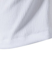 White cotton undershirt with textured fabric and visible stitching detail.