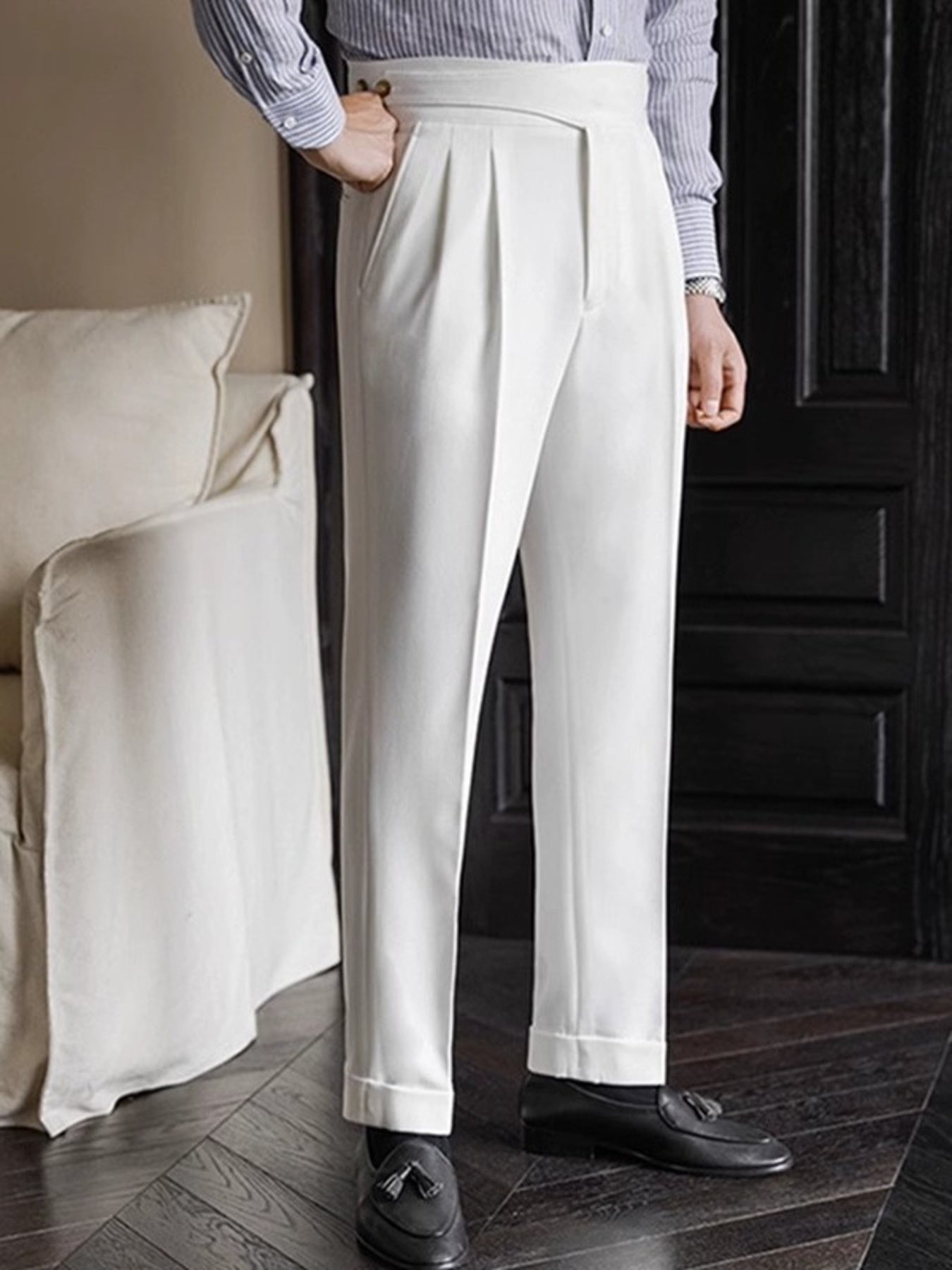 White pleated wide-leg dress pants with cuffed hem and a classic fit.