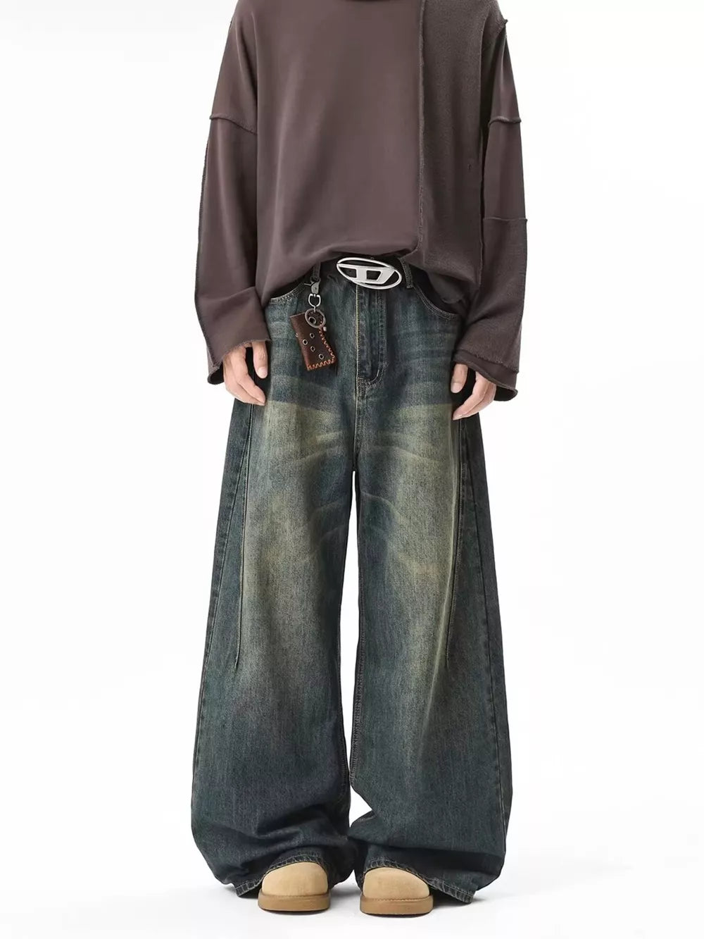Vintage wash baggy blue cotton jeans with a belted waist and oversized fit.