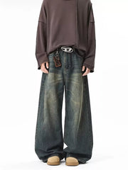 Vintage wash baggy blue cotton jeans with a belted waist and oversized fit.
