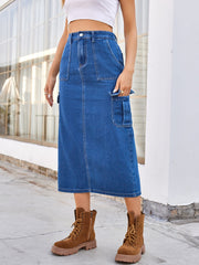 Medium wash denim midi skirt with cargo pockets and a casual, chic style.