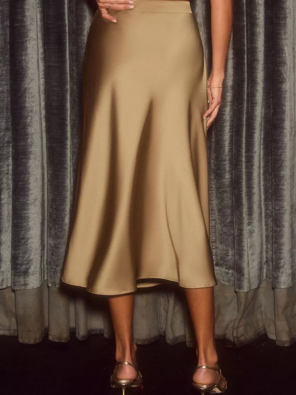 Elegant flowing satin midi skirt in khaki with an a-line cut.