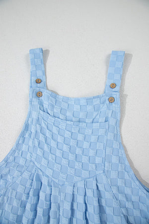 Light blue textured checkered jumpsuit with button straps and a chest pocket.