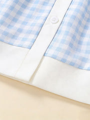 Sky blue gingham toddler dress with white trim and button detail.