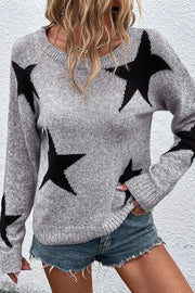 Gray knit jumper with black star pattern, crew neck, long sleeves.